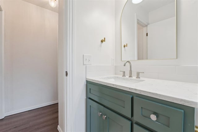 1729 Dena Dr, Edmond, OK 73003 - bathroom featuring vanity, wood finished floors, and tasteful backsplash