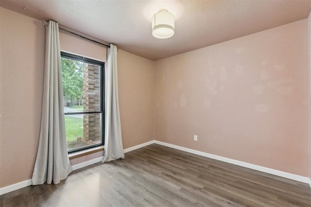 1729 Dena Dr, Edmond, OK 73003 - spare room with wood finished floors and baseboards