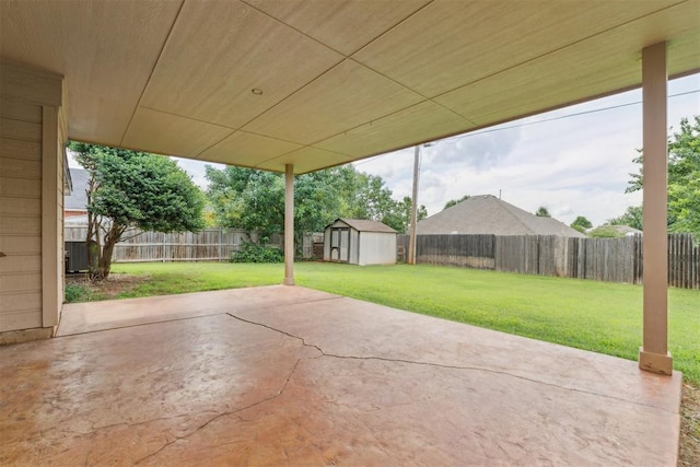 1729 Dena Dr, Edmond, OK 73003 - fenced backyard featuring a storage unit and a patio area