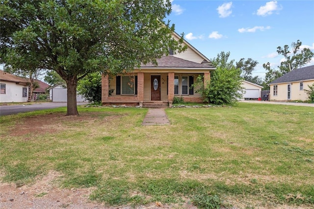625 N Broadway St, Hydro, OK 73048 - view of front of property with brick siding, a porch, a front lawn, and a garage