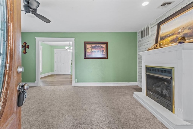 625 N Broadway St, Hydro, OK 73048 - unfurnished living room with carpet, a ceiling fan, and a fireplace with raised hearth
