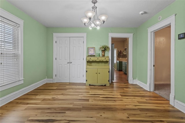 625 N Broadway St, Hydro, OK 73048 - unfurnished dining area with light wood-style flooring and a chandelier