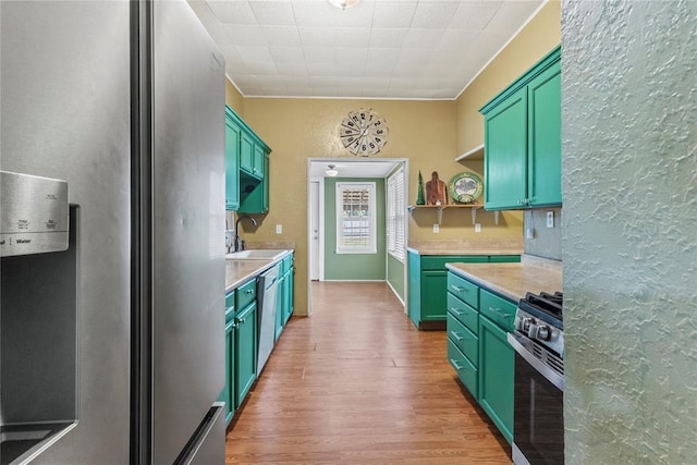 625 N Broadway St, Hydro, OK 73048 - kitchen with appliances with stainless steel finishes, green cabinetry, light wood finished floors, open shelves, and a textured wall