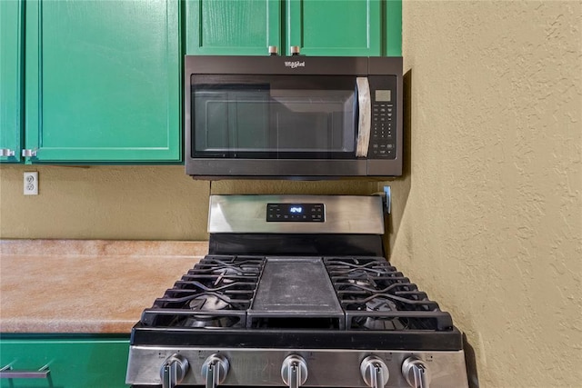 625 N Broadway St, Hydro, OK 73048 - kitchen view of black microwave, stainless steel range with gas stovetop, and a textured wall