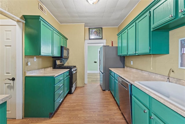 625 N Broadway St, Hydro, OK 73048 - kitchen featuring appliances with stainless steel finishes, light wood-style flooring, and light countertops