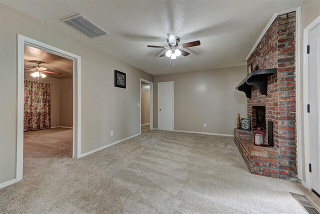 3708 Greenway Ter, Del City, OK 73115 - unfurnished living room featuring ceiling fan, carpet flooring, a textured ceiling, and a brick fireplace
