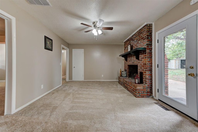 3708 Greenway Ter, Del City, OK 73115 - unfurnished living room with ceiling fan, carpet floors, a textured ceiling, and a fireplace