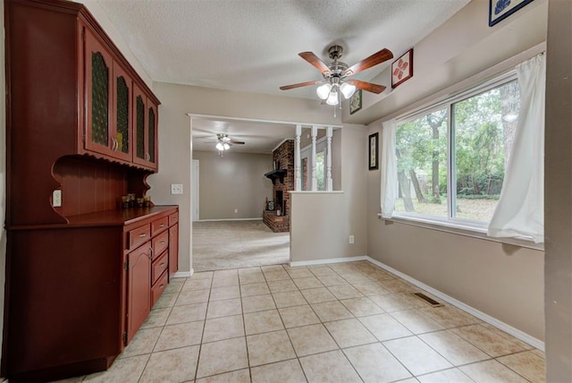 3708 Greenway Ter, Del City, OK 73115 - spare room with ceiling fan, a textured ceiling, light tile patterned flooring, and light carpet