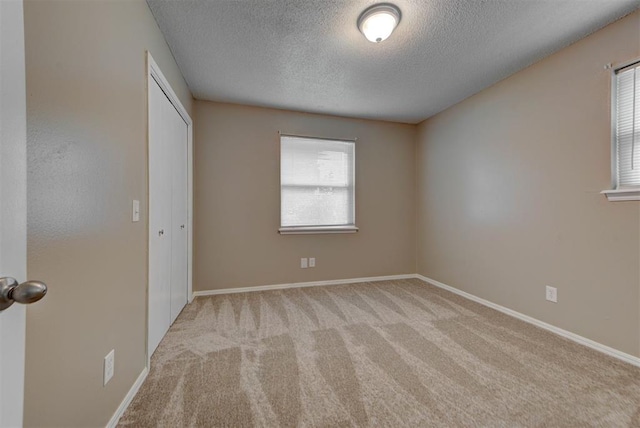 3708 Greenway Ter, Del City, OK 73115 - unfurnished bedroom featuring a textured ceiling, carpet flooring, and a closet