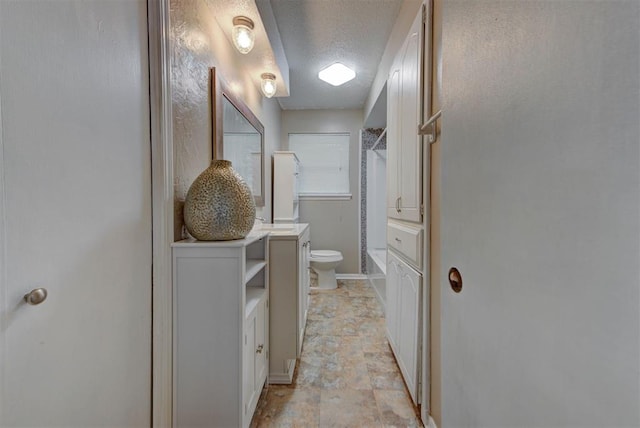 3708 Greenway Ter, Del City, OK 73115 - full bath featuring vanity, a textured ceiling, shower / bath combination, and stone finish flooring
