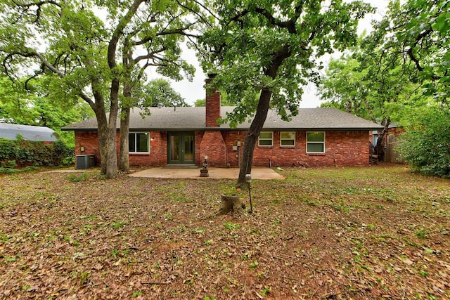3708 Greenway Ter, Del City, OK 73115 - rear view of house with a chimney, a patio, brick siding, and french doors