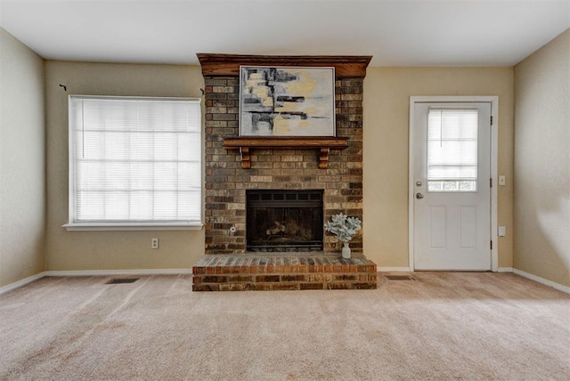 442 W Apple Branch Way, Mustang, OK 73064 - unfurnished living room with plenty of natural light, carpet, and a fireplace