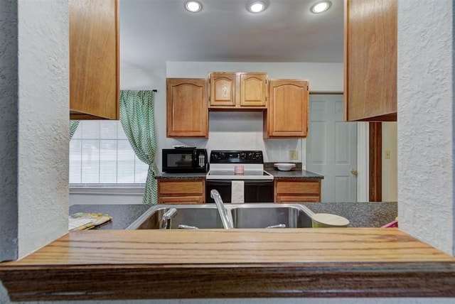 442 W Apple Branch Way, Mustang, OK 73064 - kitchen with electric stove, black microwave, a textured wall, and recessed lighting