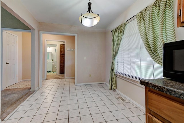 442 W Apple Branch Way, Mustang, OK 73064 - unfurnished dining area featuring baseboards and light tile patterned floors