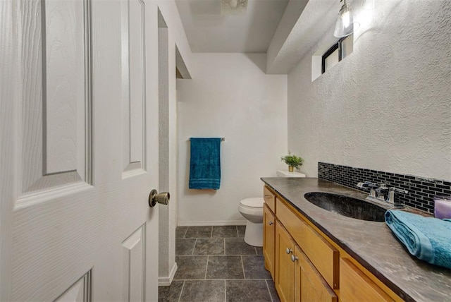 442 W Apple Branch Way, Mustang, OK 73064 - bathroom with vanity, stone finish floors, and tasteful backsplash