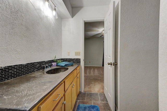 442 W Apple Branch Way, Mustang, OK 73064 - bathroom featuring a textured wall, backsplash, tile patterned flooring, and vanity