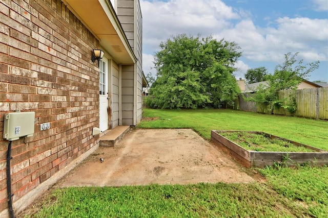442 W Apple Branch Way, Mustang, OK 73064 - fenced backyard featuring a patio and a vegetable garden