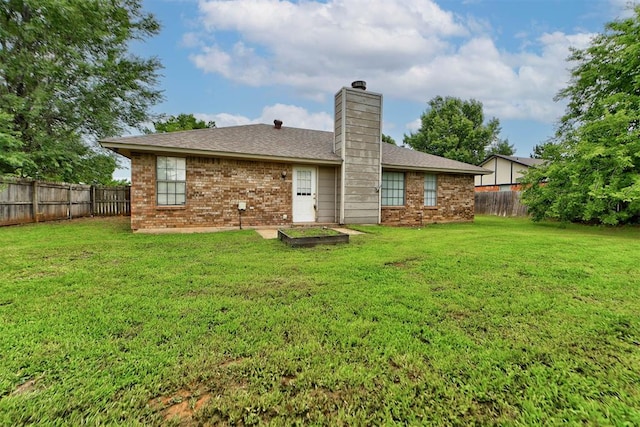 442 W Apple Branch Way, Mustang, OK 73064 - back of house with a fenced backyard, brick siding, a chimney, and a shingled roof