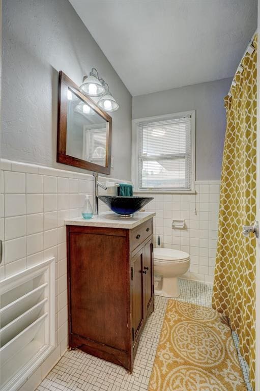 1701 Andover Ct, The Village, OK 73120 - bathroom featuring tile walls, vanity, tile patterned flooring, wainscoting, and a shower with curtain
