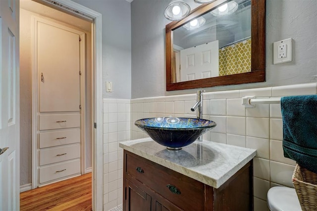1701 Andover Ct, The Village, OK 73120 - full bath featuring tile walls, vanity, a wainscoted wall, and wood finished floors