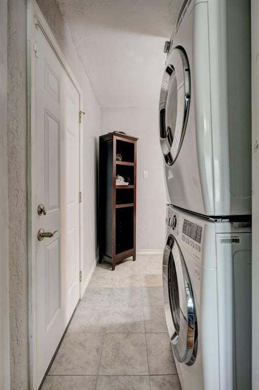 1701 Andover Ct, The Village, OK 73120 - washroom with stacked washing machine and dryer and light tile patterned floors