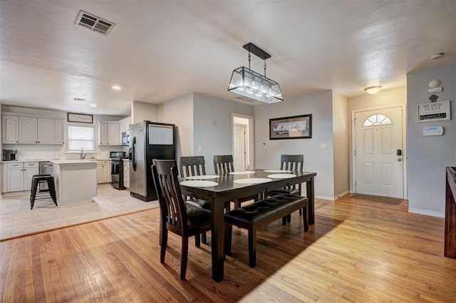 1701 Andover Ct, The Village, OK 73120 - dining area featuring light wood-style flooring and baseboards