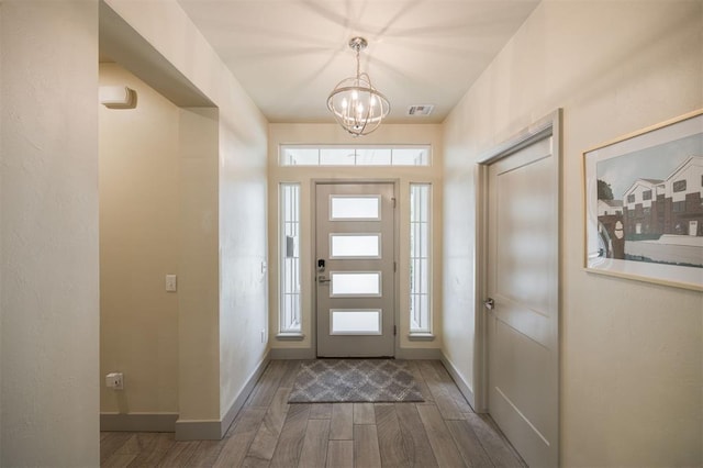 5521 N Miller Ave, Oklahoma City, OK 73112 - entrance foyer with wood finished floors and a chandelier