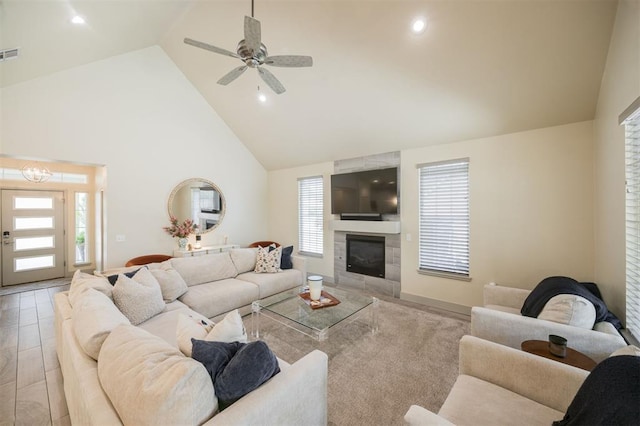 5521 N Miller Ave, Oklahoma City, OK 73112 - living room with high vaulted ceiling, a tile fireplace, a ceiling fan, and recessed lighting