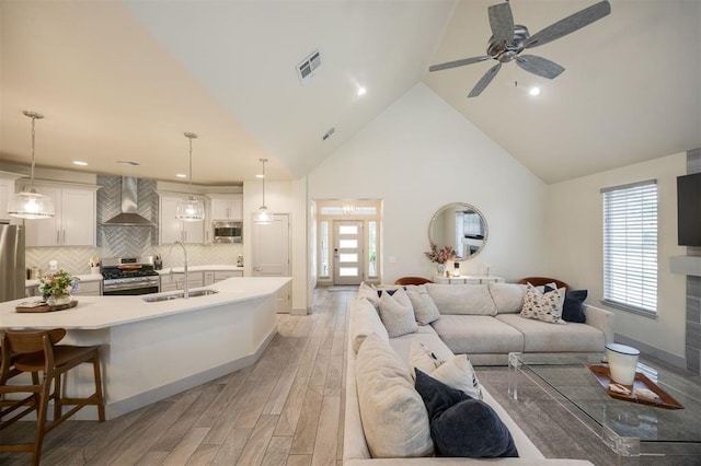 5521 N Miller Ave, Oklahoma City, OK 73112 - living room with light wood-style floors, a ceiling fan, healthy amount of natural light, recessed lighting, and high vaulted ceiling
