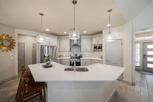5521 N Miller Ave, Oklahoma City, OK 73112 - kitchen featuring stainless steel appliances, tasteful backsplash, light countertops, a spacious island, and a breakfast bar area