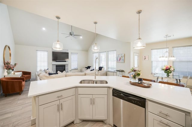 5521 N Miller Ave, Oklahoma City, OK 73112 - kitchen with dishwasher, a ceiling fan, vaulted ceiling, light countertops, and plenty of natural light