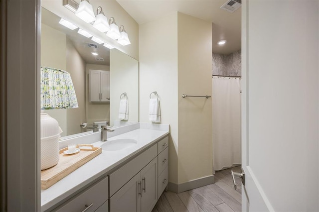 5521 N Miller Ave, Oklahoma City, OK 73112 - bathroom with vanity and wood finished floors