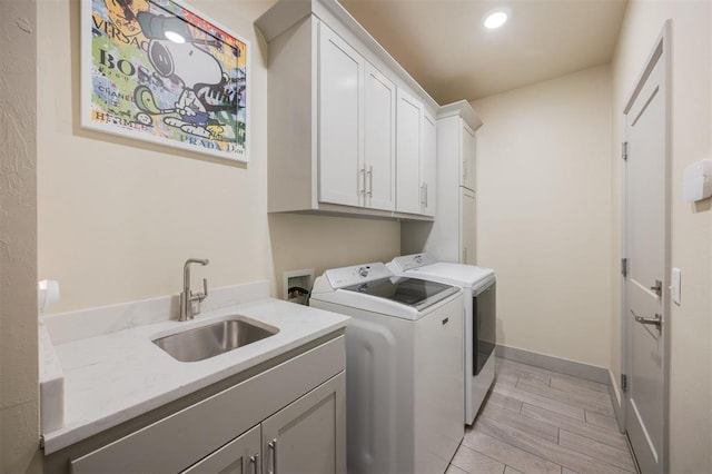 5521 N Miller Ave, Oklahoma City, OK 73112 - washroom featuring cabinet space, washer and dryer, light wood-type flooring, and recessed lighting