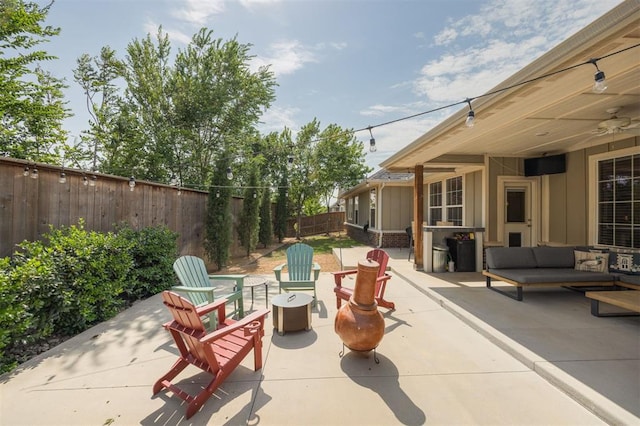 5521 N Miller Ave, Oklahoma City, OK 73112 - fenced backyard featuring a patio area, an outdoor living space with a fire pit, and ceiling fan