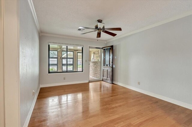 829 Arnold Ave, Moore, OK 73160 - unfurnished room with a textured ceiling, wood finished floors, ceiling fan, and ornamental molding