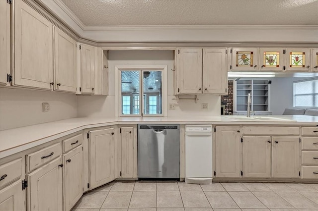 829 Arnold Ave, Moore, OK 73160 - kitchen with stainless steel dishwasher, a textured ceiling, light countertops, ornamental molding, and light tile patterned floors