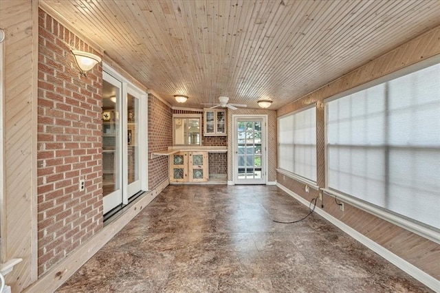829 Arnold Ave, Moore, OK 73160 - unfurnished sunroom featuring brick wall and wooden ceiling