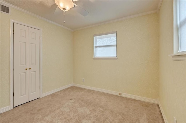 829 Arnold Ave, Moore, OK 73160 - unfurnished bedroom with light carpet, ornamental molding, a closet, and a ceiling fan