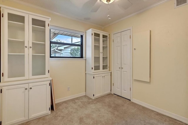 829 Arnold Ave, Moore, OK 73160 - empty room featuring crown molding, light carpet, and a ceiling fan