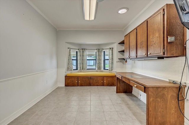 829 Arnold Ave, Moore, OK 73160 - kitchen featuring crown molding, brown cabinets, decorative backsplash, open shelves, and light tile patterned floors