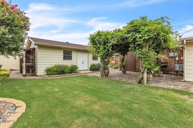 829 Arnold Ave, Moore, OK 73160 - rear view of house with an outbuilding and a patio area