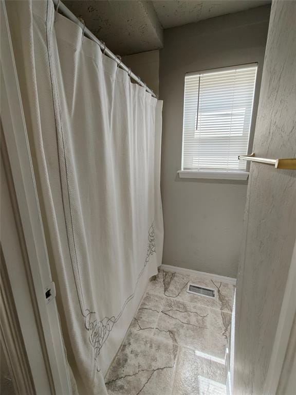 11208 NW 113th St, Yukon, OK 73099 - full bathroom with a shower with shower curtain and baseboards