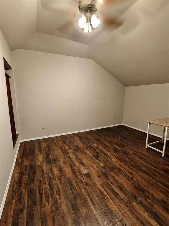 11208 NW 113th St, Yukon, OK 73099 - bonus room with lofted ceiling, a ceiling fan, and dark wood-style flooring