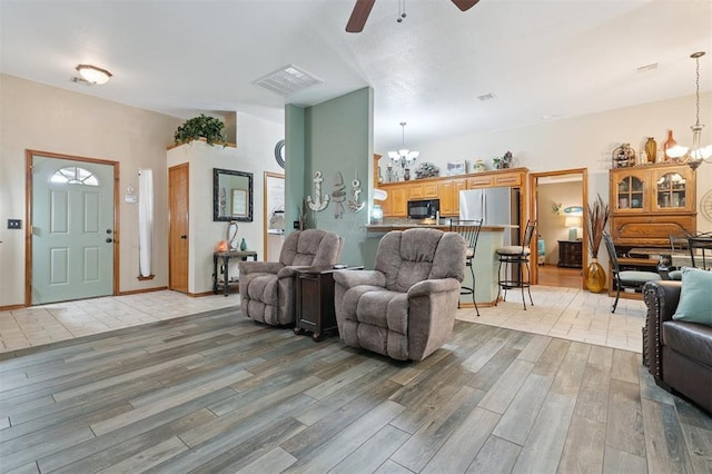 6005 SE 82nd Cir, Oklahoma City, OK 73135 - living area featuring a chandelier, ceiling fan, and light wood finished floors