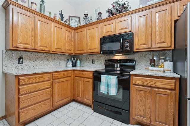 6005 SE 82nd Cir, Oklahoma City, OK 73135 - kitchen with black appliances, tasteful backsplash, and light stone countertops