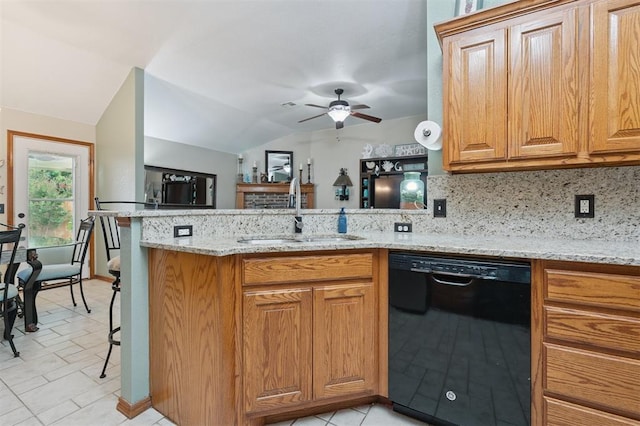 6005 SE 82nd Cir, Oklahoma City, OK 73135 - kitchen with black dishwasher, a peninsula, vaulted ceiling, a ceiling fan, and light stone countertops