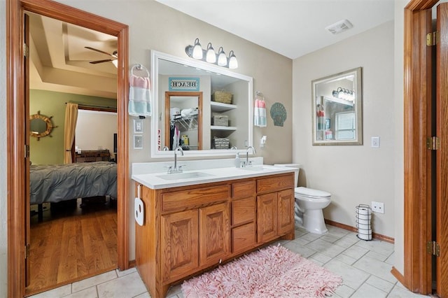 6005 SE 82nd Cir, Oklahoma City, OK 73135 - bathroom featuring connected bathroom, double vanity, tile patterned floors, and ceiling fan
