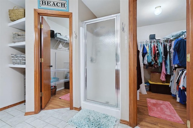 6005 SE 82nd Cir, Oklahoma City, OK 73135 - bathroom featuring a walk in closet, a stall shower, and tile patterned flooring