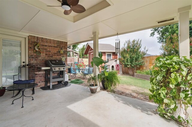 6005 SE 82nd Cir, Oklahoma City, OK 73135 - fenced backyard with a patio, ceiling fan, a grill, and a storage unit