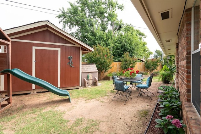 6005 SE 82nd Cir, Oklahoma City, OK 73135 - view of yard featuring a storage unit and outdoor dining space